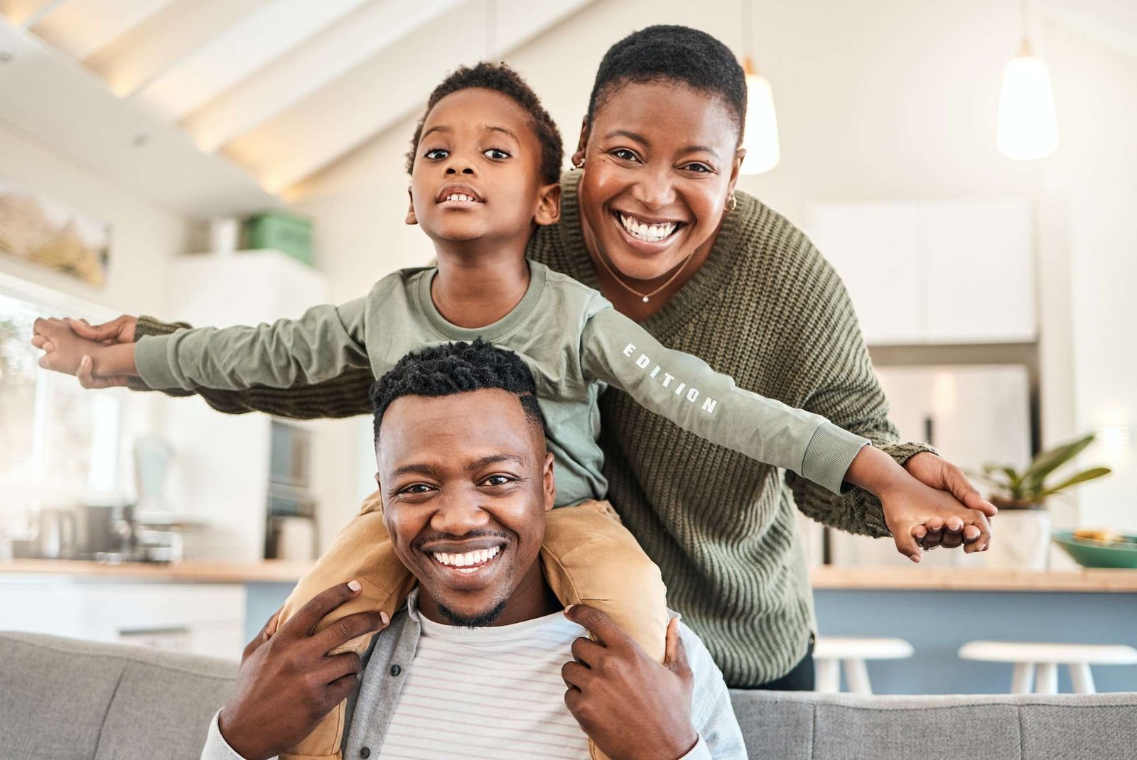 Shot of a happy young family playing together on the sofa at home